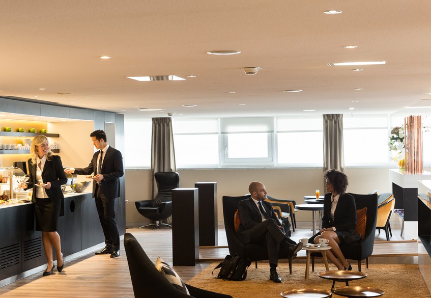 Passengers eating and drinking in the First Class Section of the Star Alliance Lounge