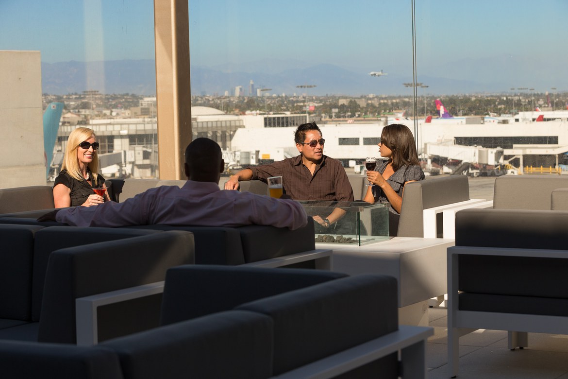 Passengers converse on the roof terrace in the L.A. sunshine